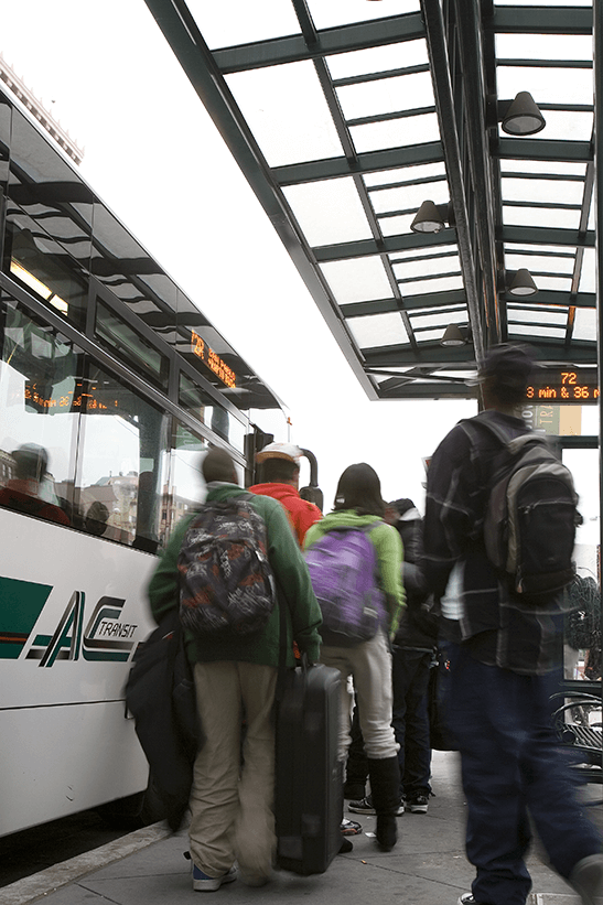 Passengers board an AC Transit bus.